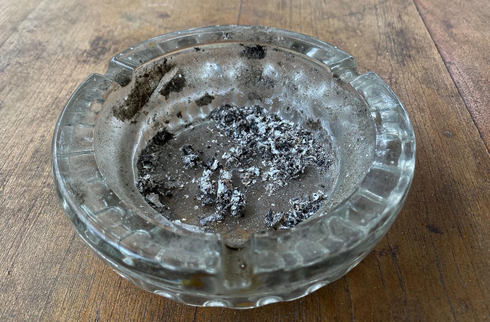 An ashtray sits with old ashes in it, unused since its owner had dental surgery.